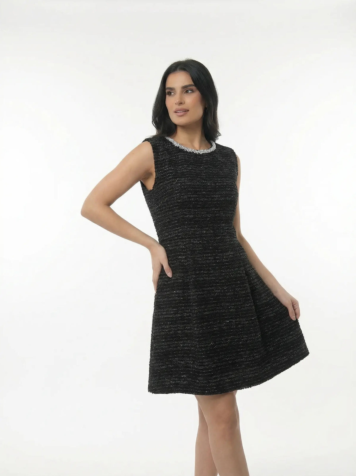 Woman wearing a black sleeveless dress on a white background