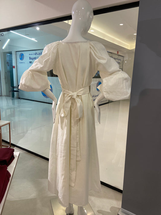 White dress on a mannequin in a store setting